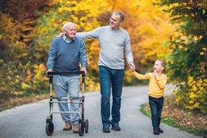 Grandfather walking with son and grandchild