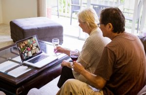 Couple Participating In Virtual Celebration With Family