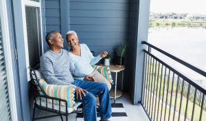 Couple Relaxing On Porch At Home